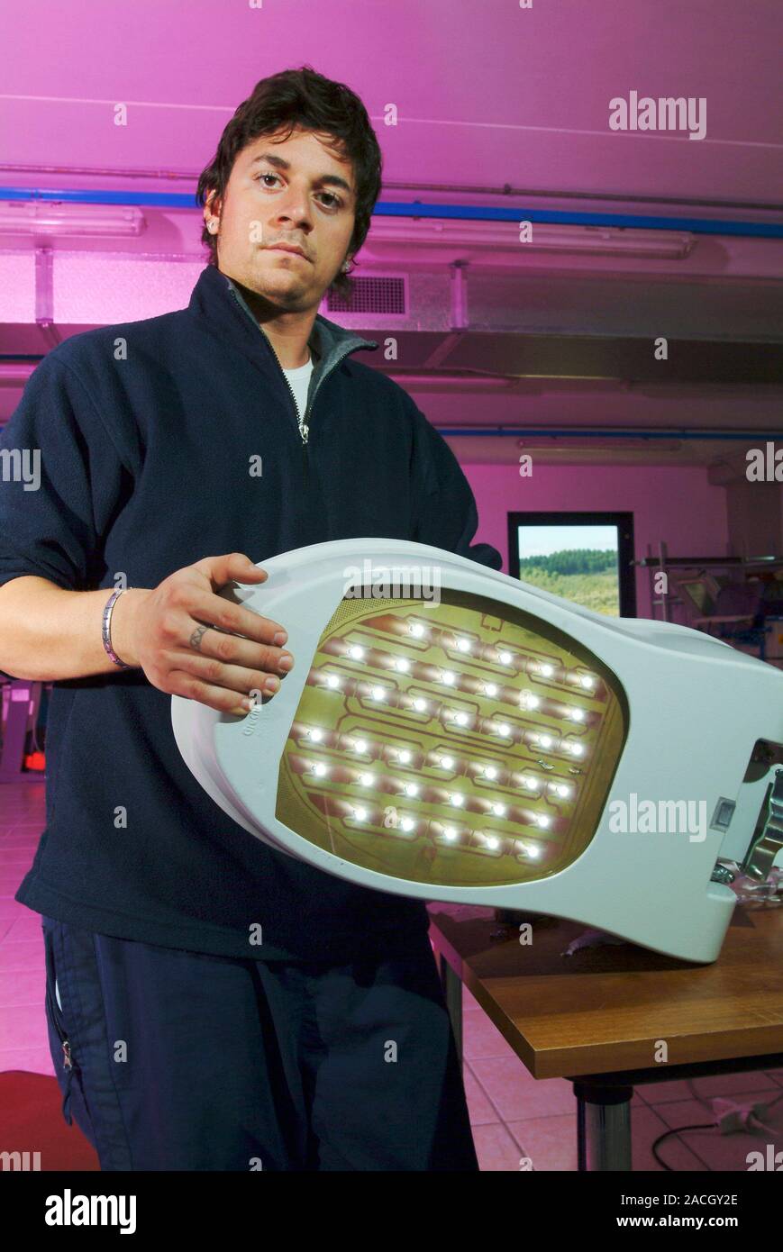 LED street lighting. Technician holding the 'element' from an LED