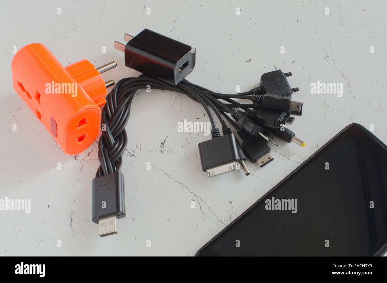 Universal USB plug with power supply for charging smartphones from various manufacturers. Stock Photo