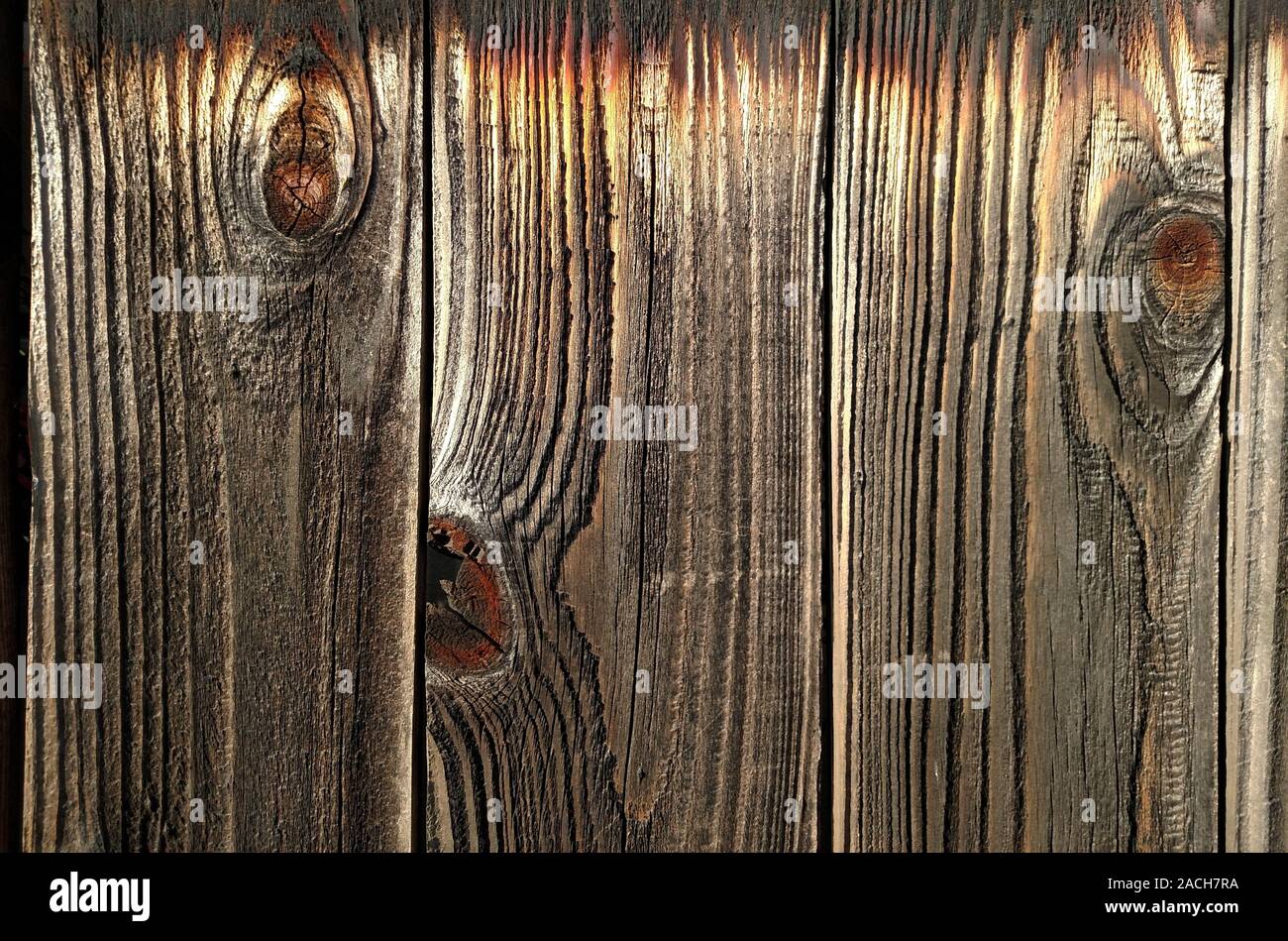 Wood grain patterns in a plank of wood in an old outdoor redwood fence Stock Photo