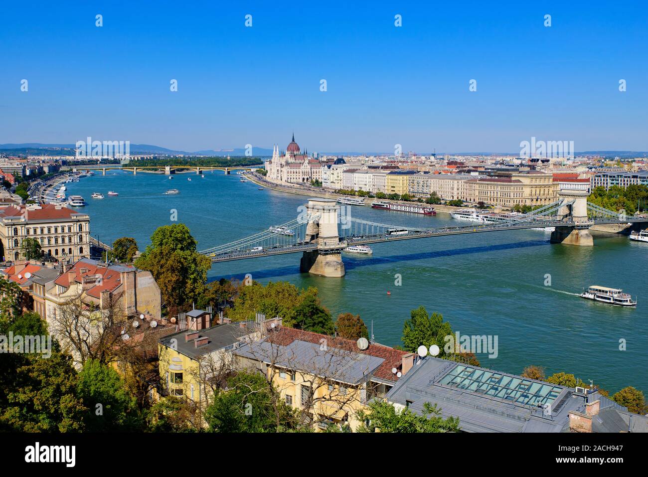 Panorama of Hungarian Parliament Building, Széchenyi Chain Bridge, and River Danube in Budapest, Hungary Stock Photo