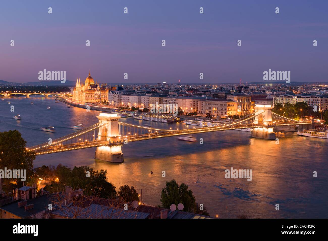 Night panorama of Hungarian Parliament Building, Széchenyi Chain Bridge, and River Danube in Budapest, Hungary Stock Photo