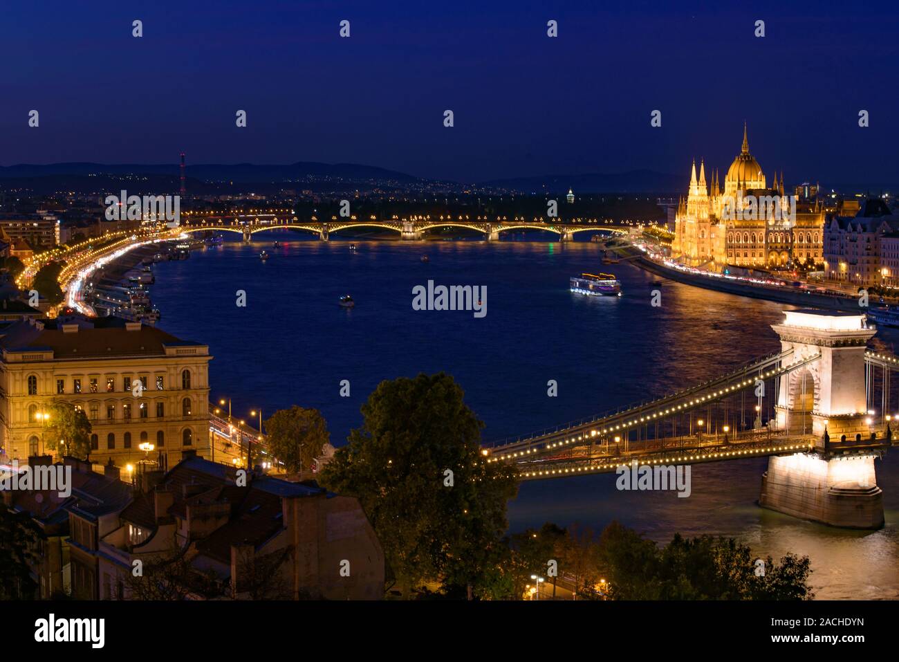 Night panorama of Hungarian Parliament Building, Széchenyi Chain Bridge, and River Danube in Budapest, Hungary Stock Photo