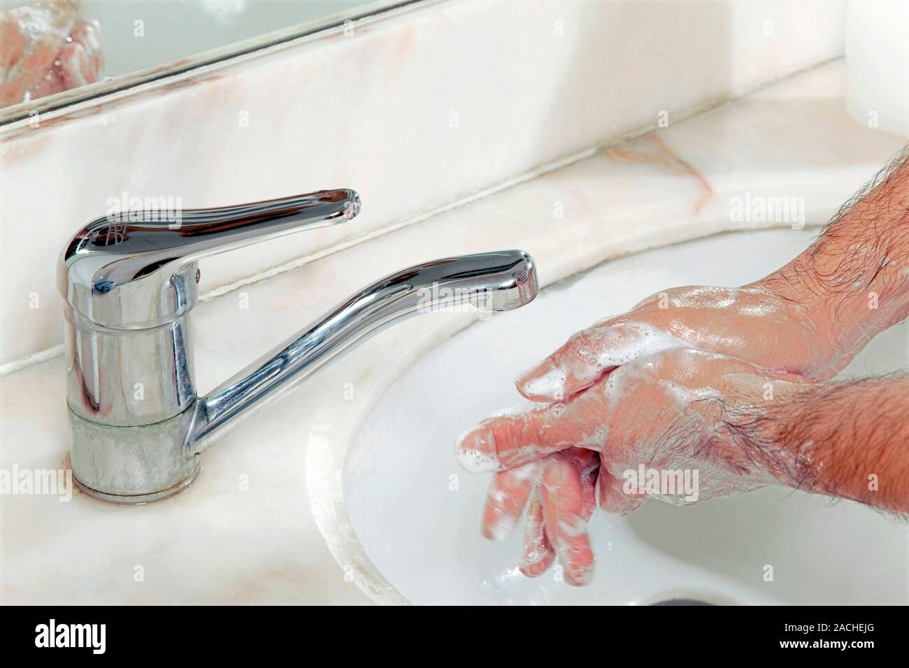 Hand washing. Person washing their hands with soap at a sink Stock ...