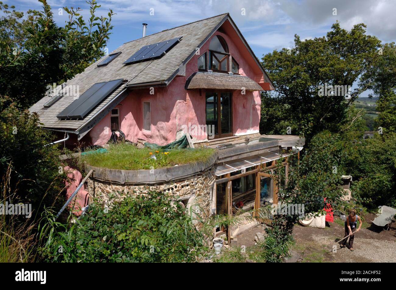 Strawbale house with solar cells and panels on its roof. Strawbale