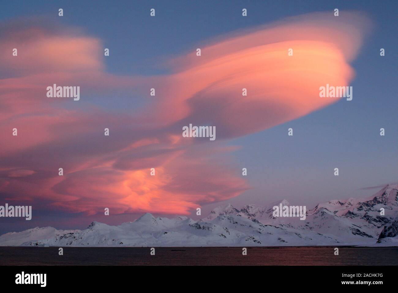 Lenticular clouds (altocumulus lenticularis) above mountains. The ...