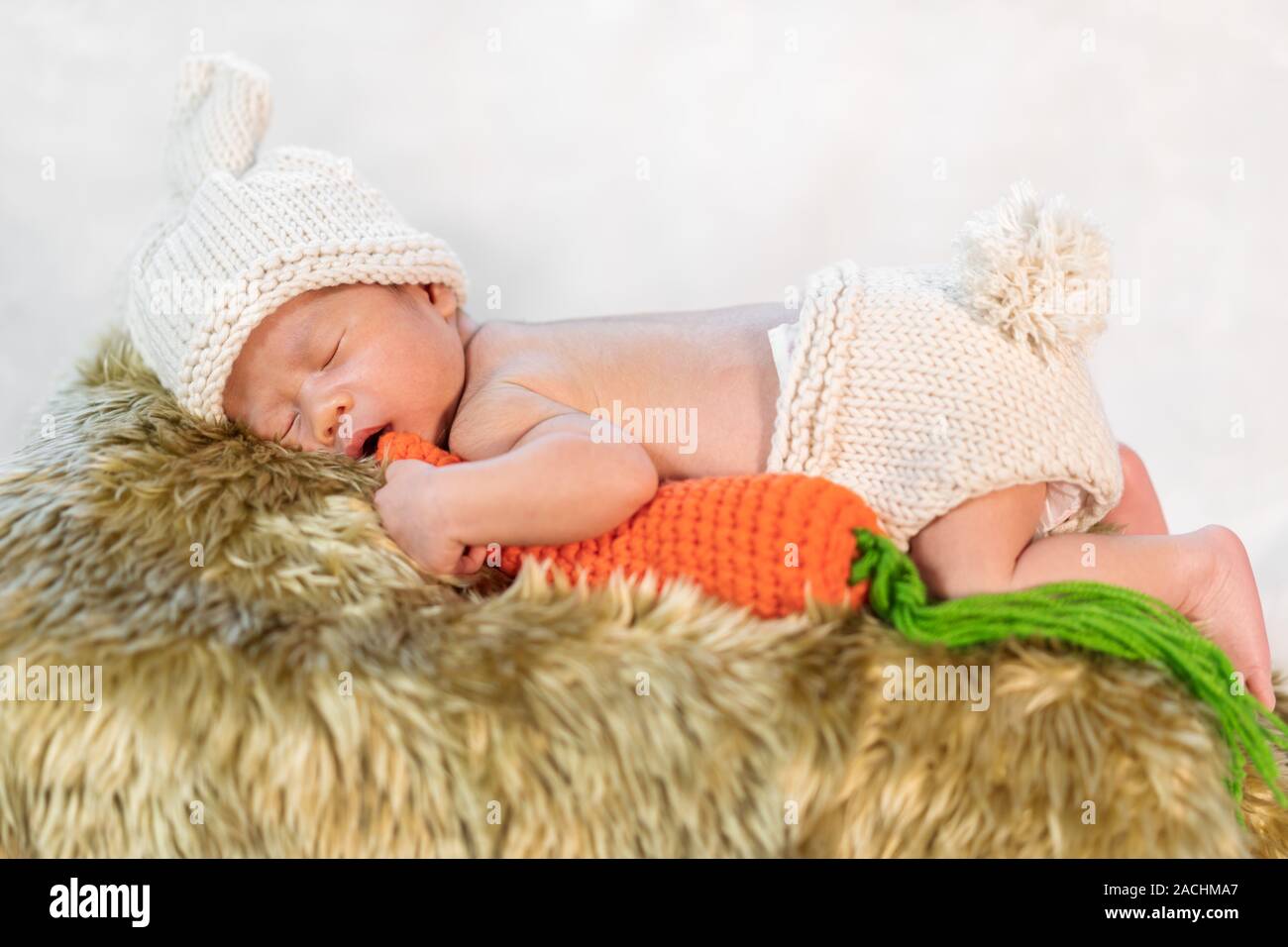 newborn baby in bunny costume sleeping on a fur bed Stock Photo Alamy