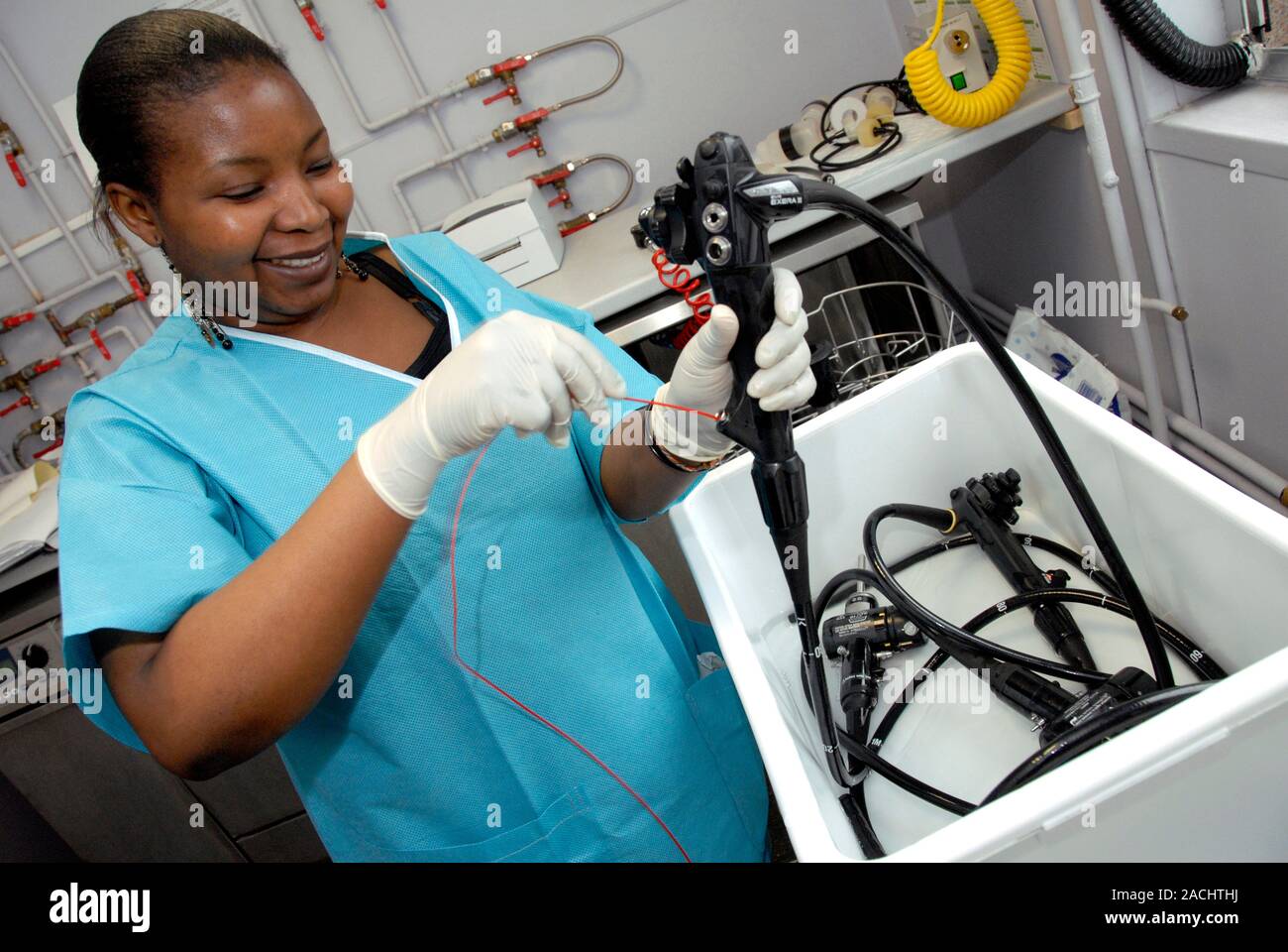 Endoscopy. Hospital worker cleaning and sterilising an endoscope after