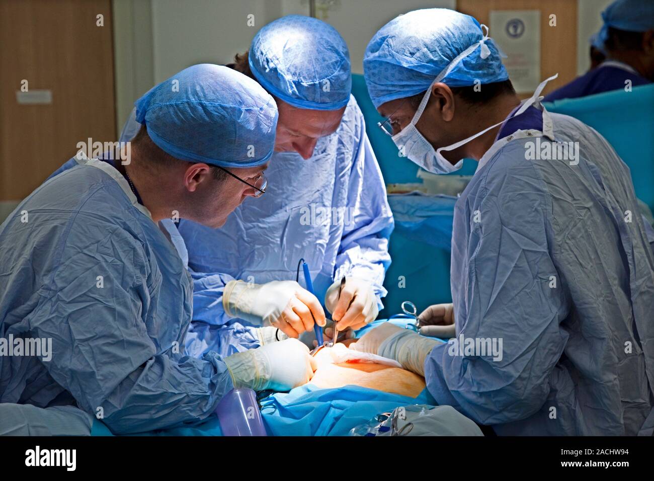Surgery surgeons operating on a patient stock photo alamy
