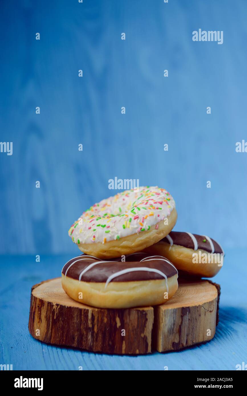 donuts lying on the table. blue background. Stock Photo