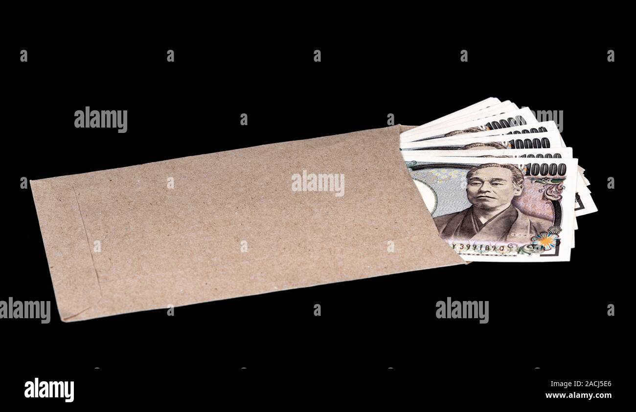 Japan money inside paper envelope on a black background Stock Photo Alamy