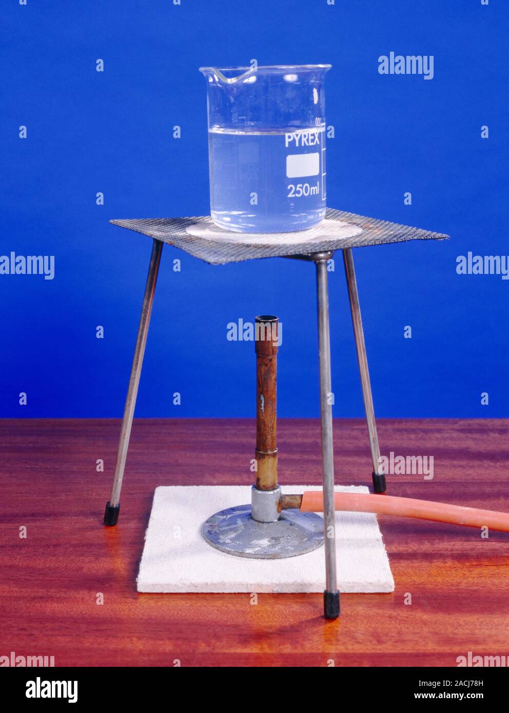Heating water in a laboratory. The water is being heated in a beaker over a bunsen burner. Pure