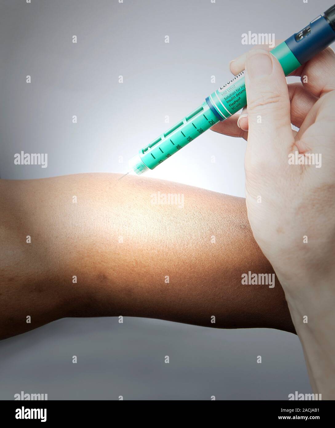 Insulin injection. Diabetic person being injected with insulin to