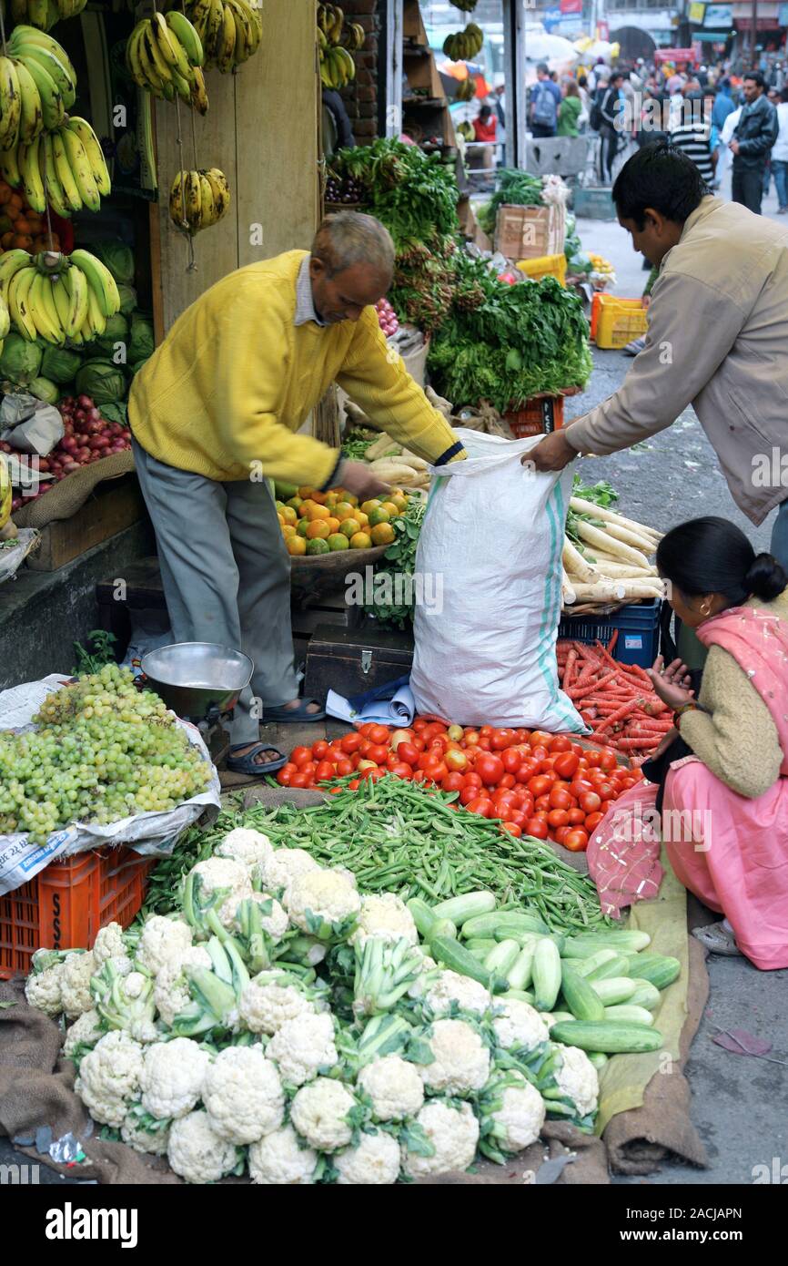 Market stall. Man selling fruit and vegetables at a market in Manali