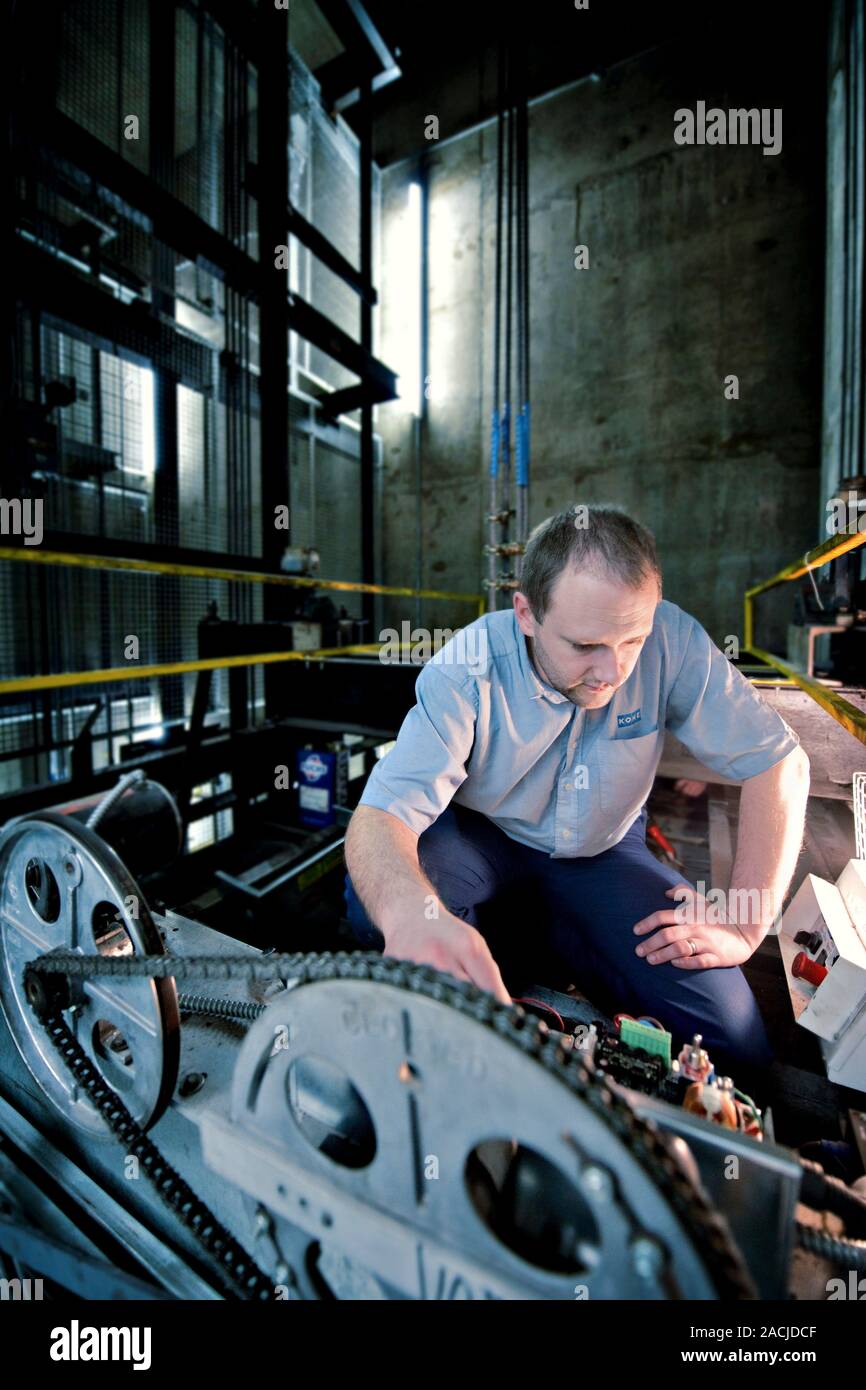 Lift engineer. Man working on a lift mechanism Stock Photo Alamy