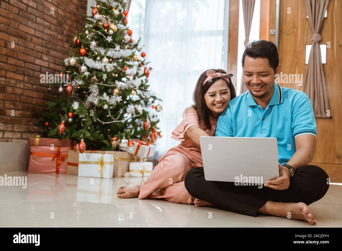 asian couple using laptop on christmas day Stock Photo