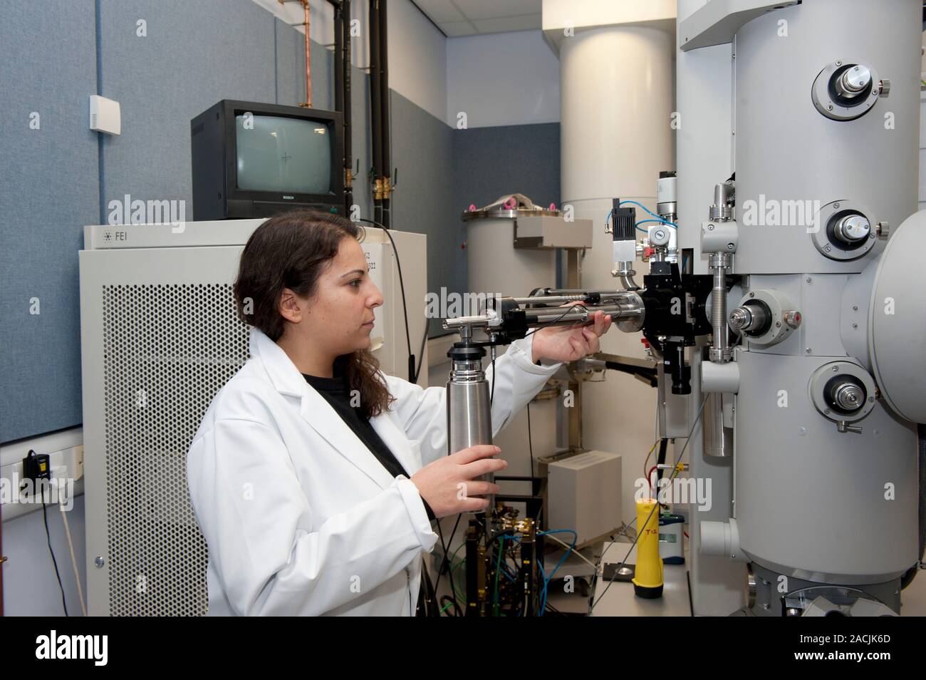 Transmission electron microscopy. Scientist introducing a specimen into