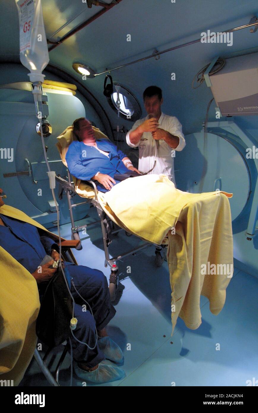 Hyperbaric chamber in a hospital. Doctor preparing a patient for ...