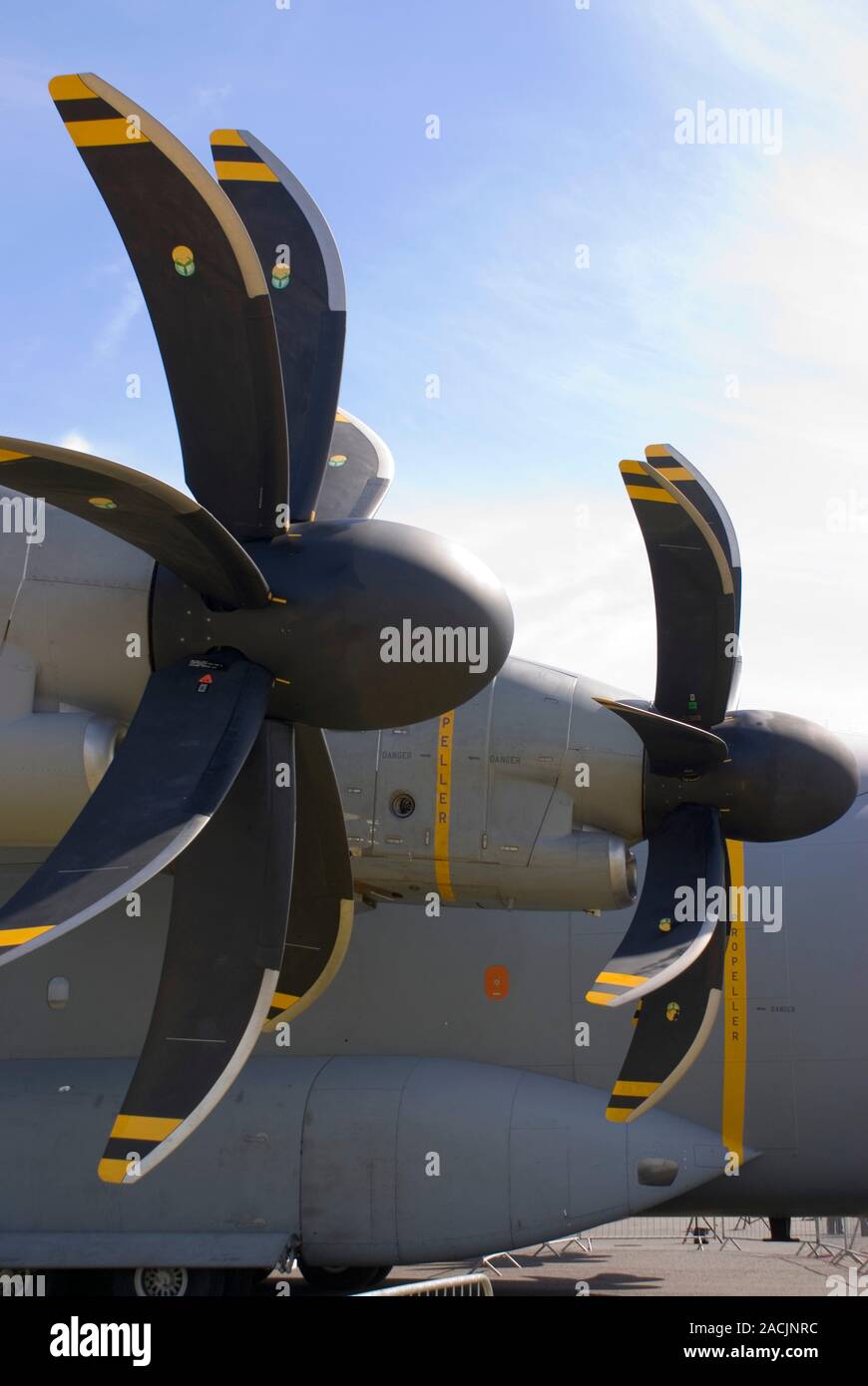 Aircraft propellers with swept back blades on military transport plane