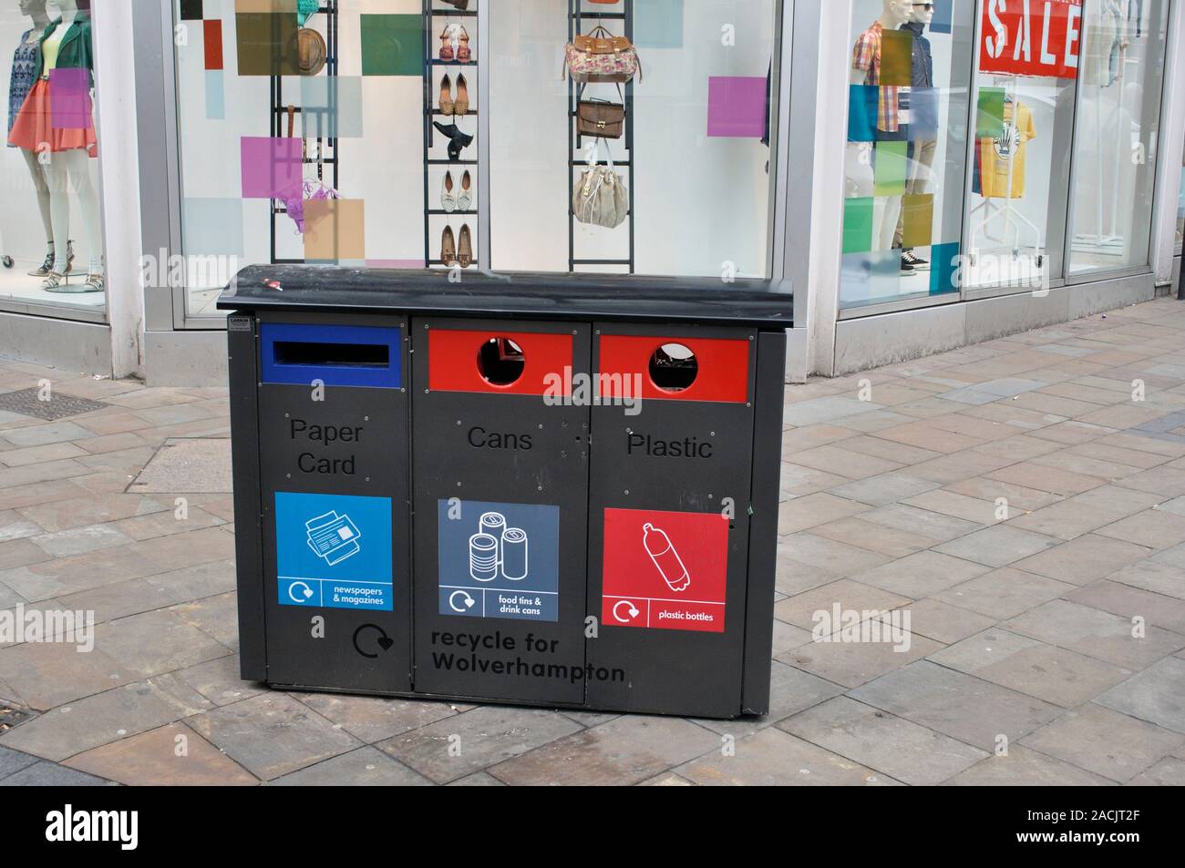 Recycling bins in front of fashion shop. Photographed in Wolverhampton