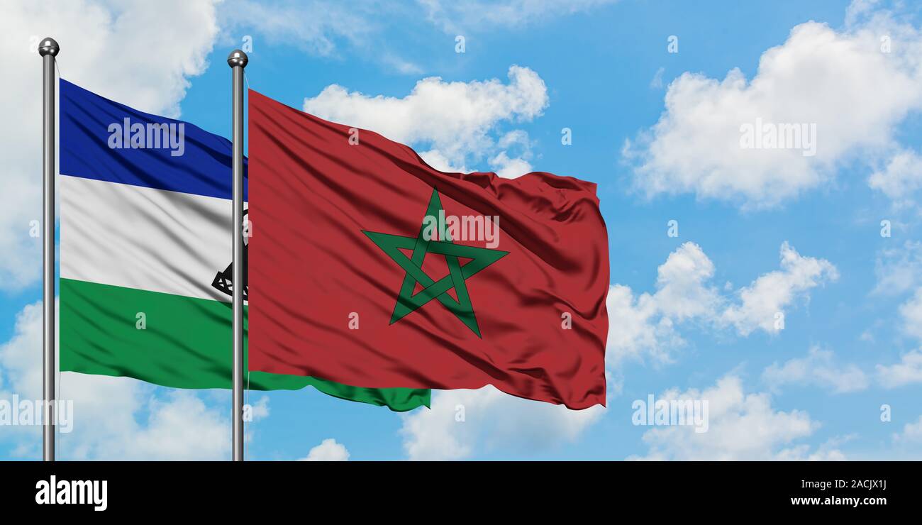 Lesotho and Morocco flag waving in the wind against white cloudy blue ...