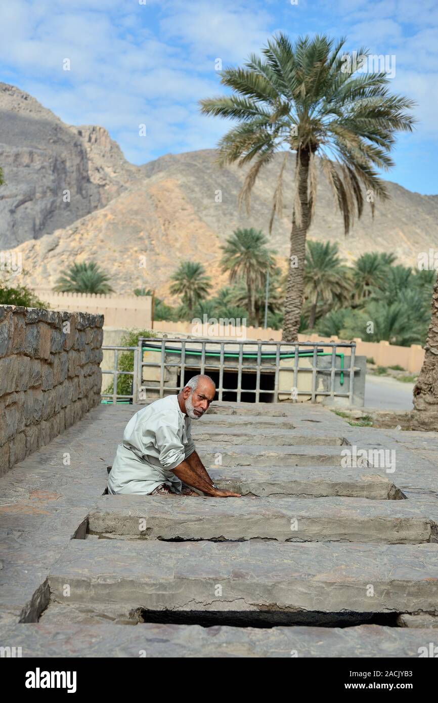 Ad Dakhiliyah, Oman, NOVEMBER 24rd, 2018: Portrait omani man which washing himself in Falaj Irrigation System Stock Photo