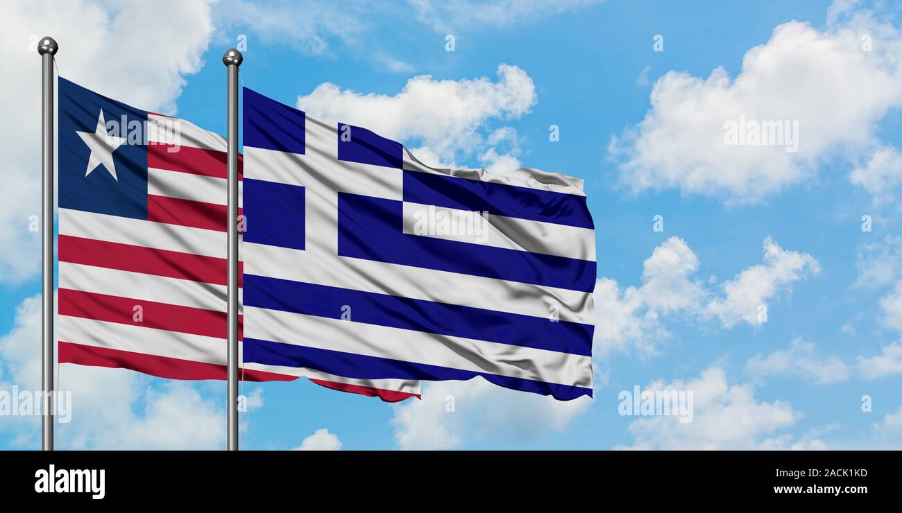 Liberia and Greece flag waving in the wind against white cloudy blue sky together. Diplomacy concept, international relations. Stock Photo