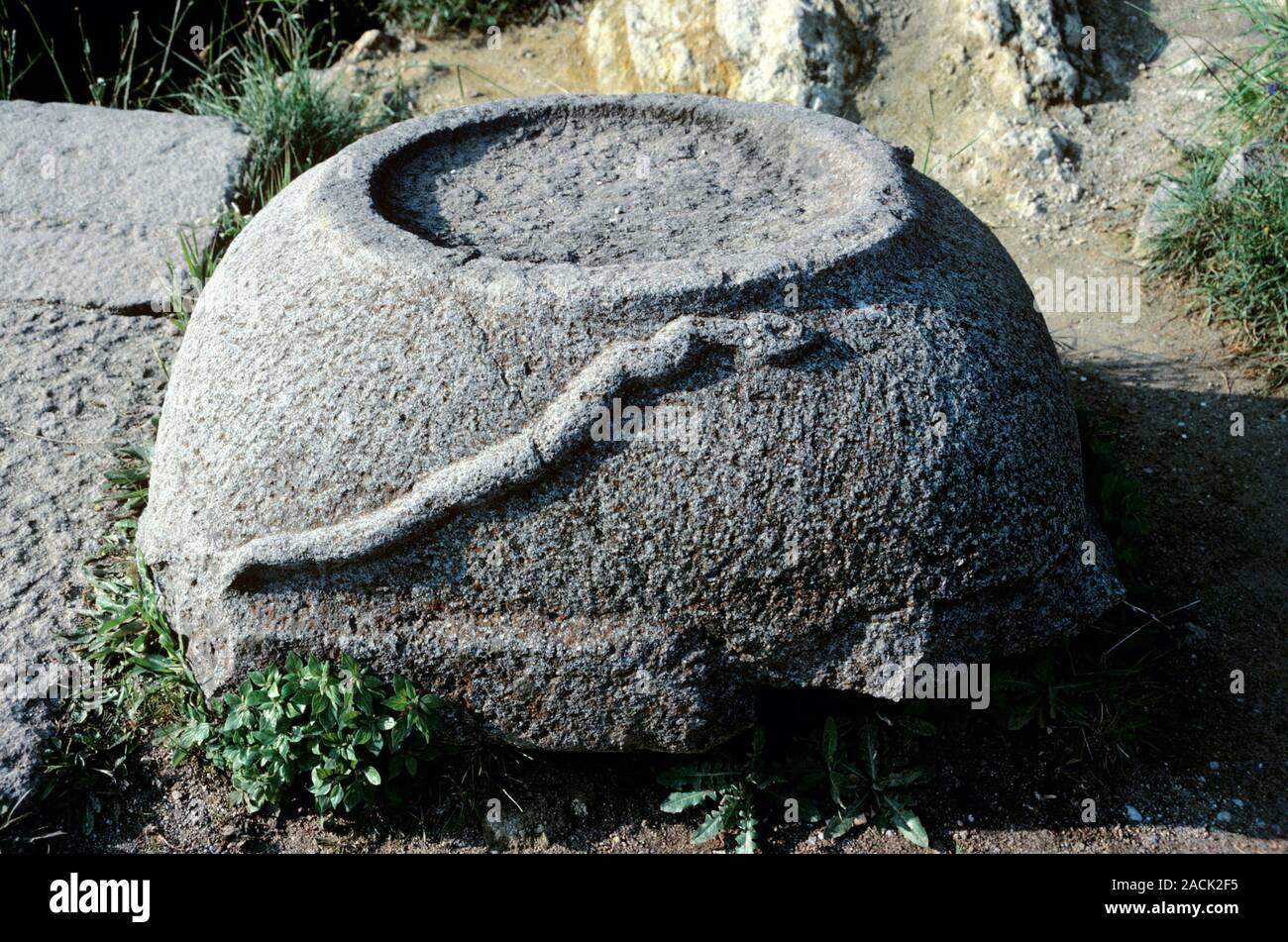 Ancient Greek carving. Relief of a snake on a stone at the Asklepieion