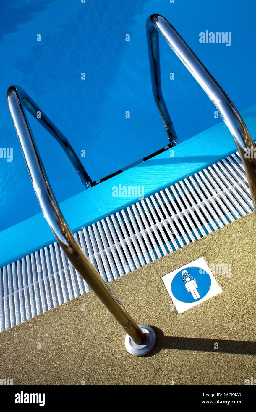 Pool hygiene. Sign on the floor by a swimming pool ladder, reminding