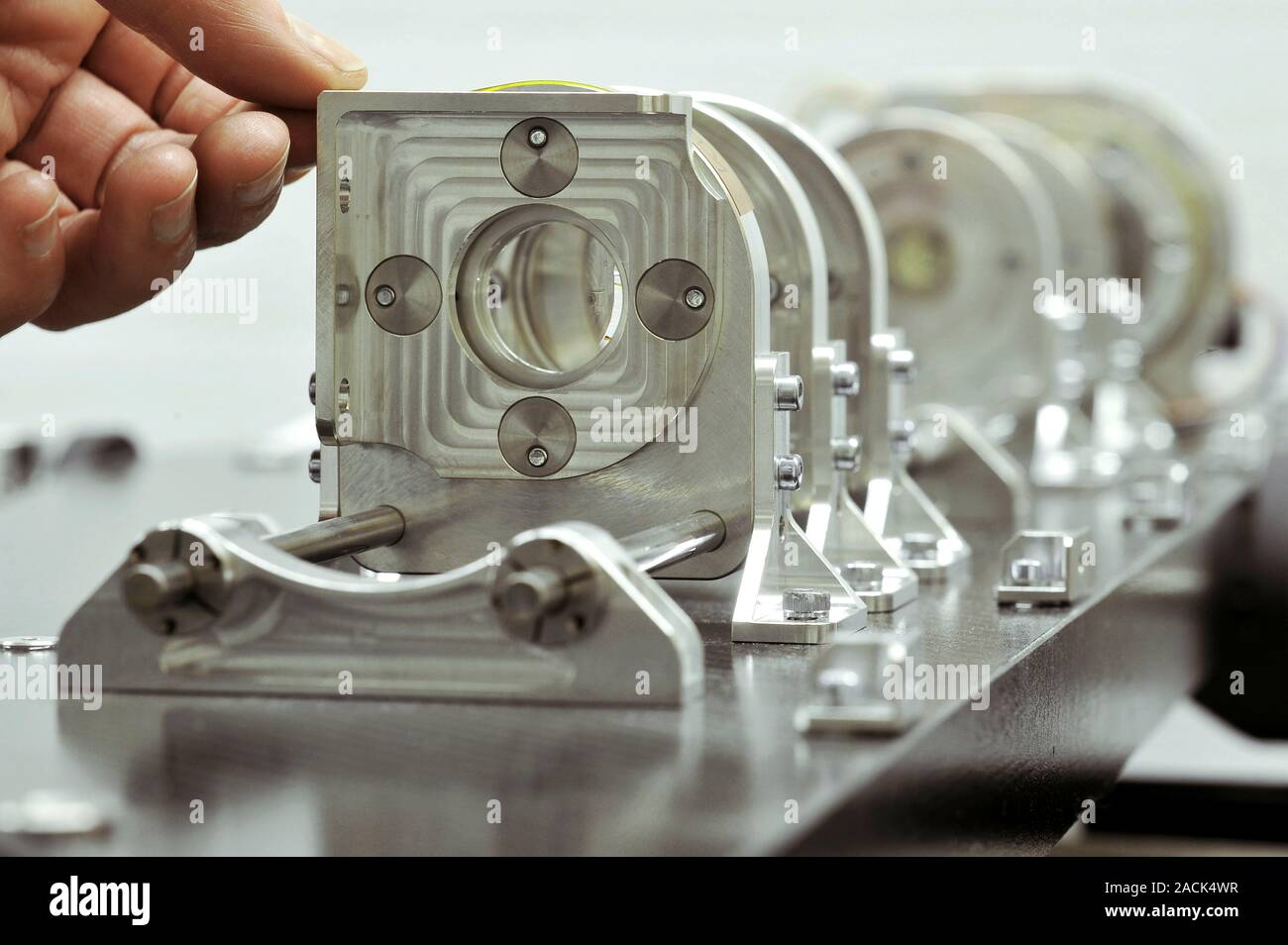 Optical science lab. Scientist working with equipment used for