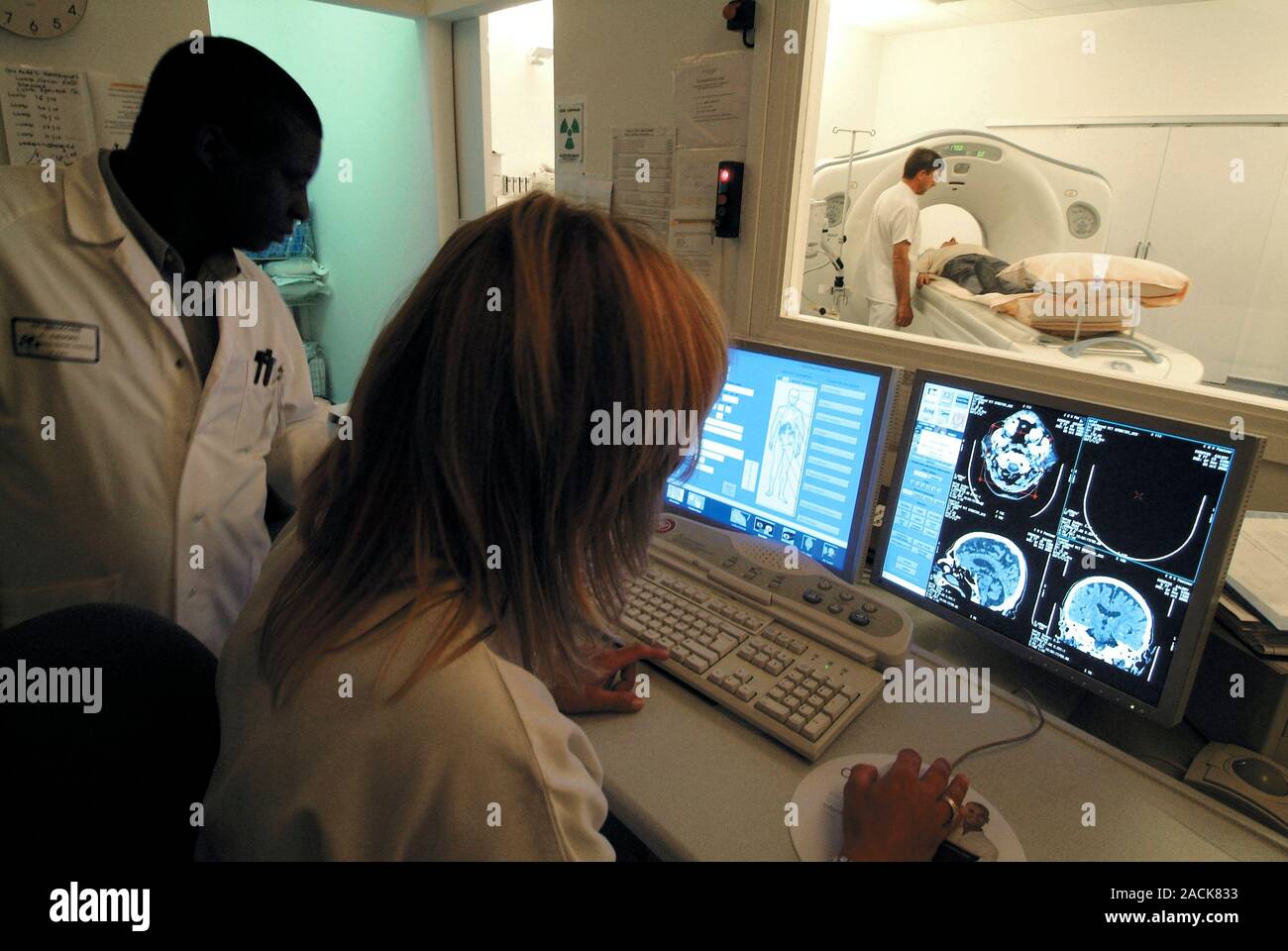 MRI scan. Radiologists in the control room of an MRI (magnetic ...