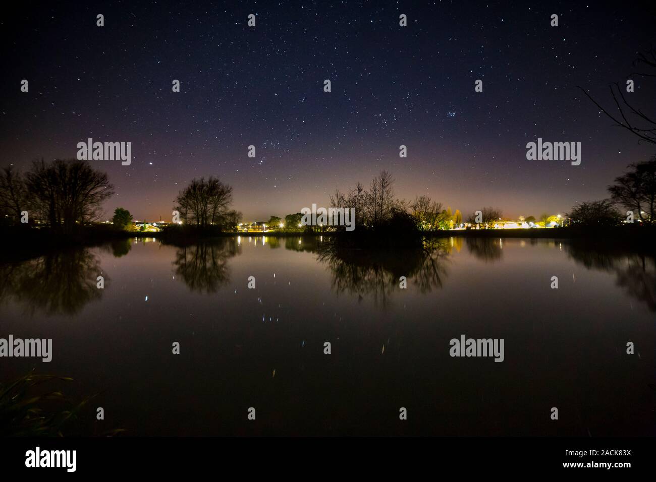 Stars and satellites reflecting in a lake, Buckley, North Wales Stock Photo