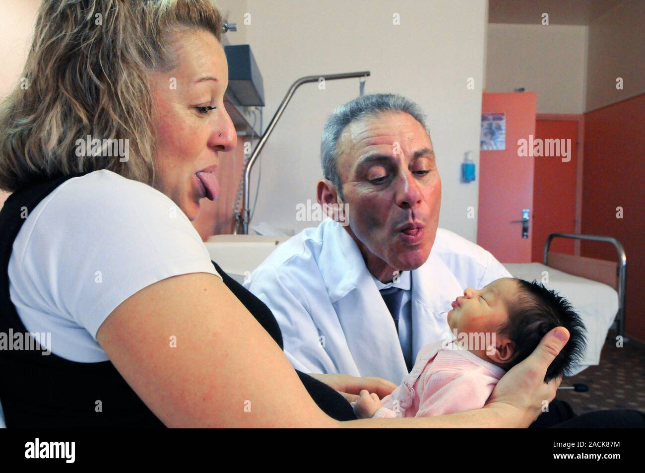 Child development research. Professor and a child's mother studying the