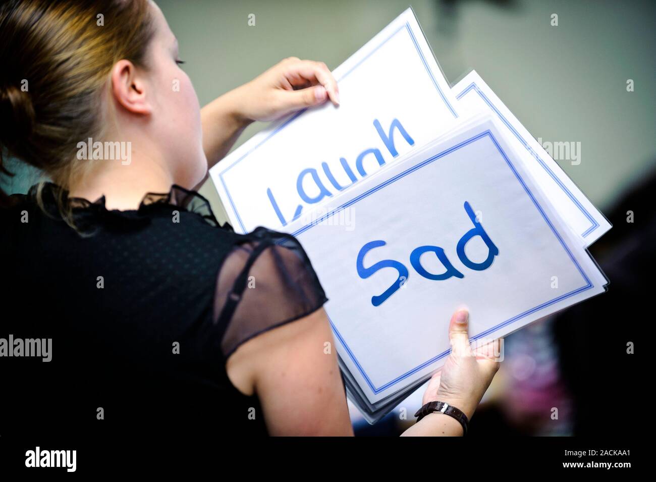Teacher sorting through cue cards Stock Photo - Alamy