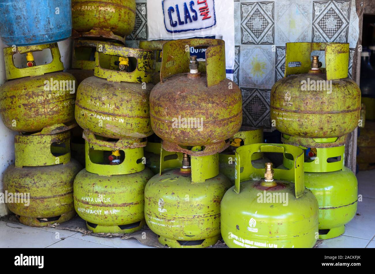 Old rusted gas cylinders for cooking are stacked on the street.  Bali, Indonesia, 2018-04-29 Stock Photo