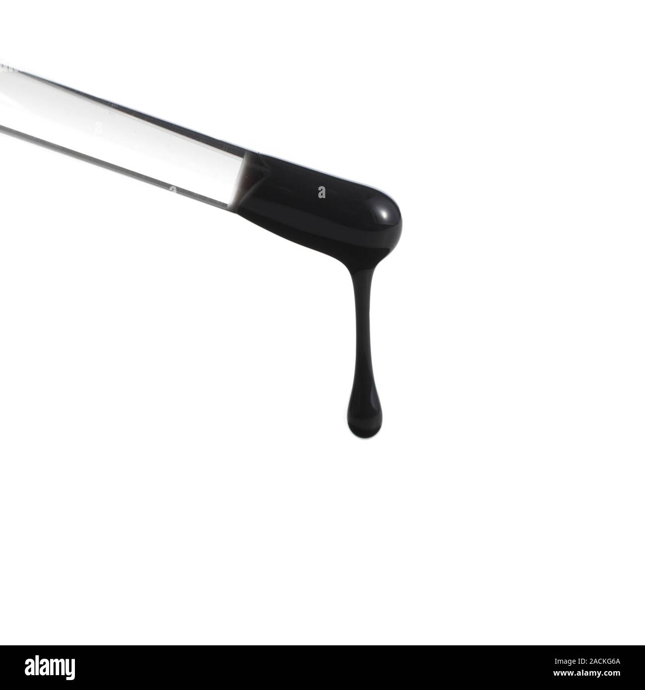 Crude oil dripping from a glass rod. This illustrates the viscosity of