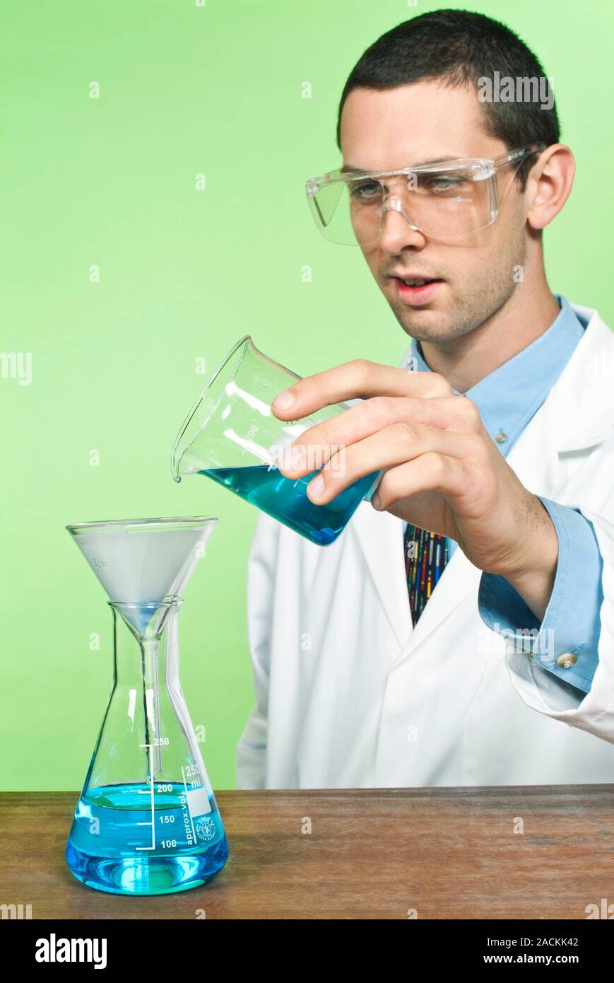 Laboratory filtration. School student using filter paper and a