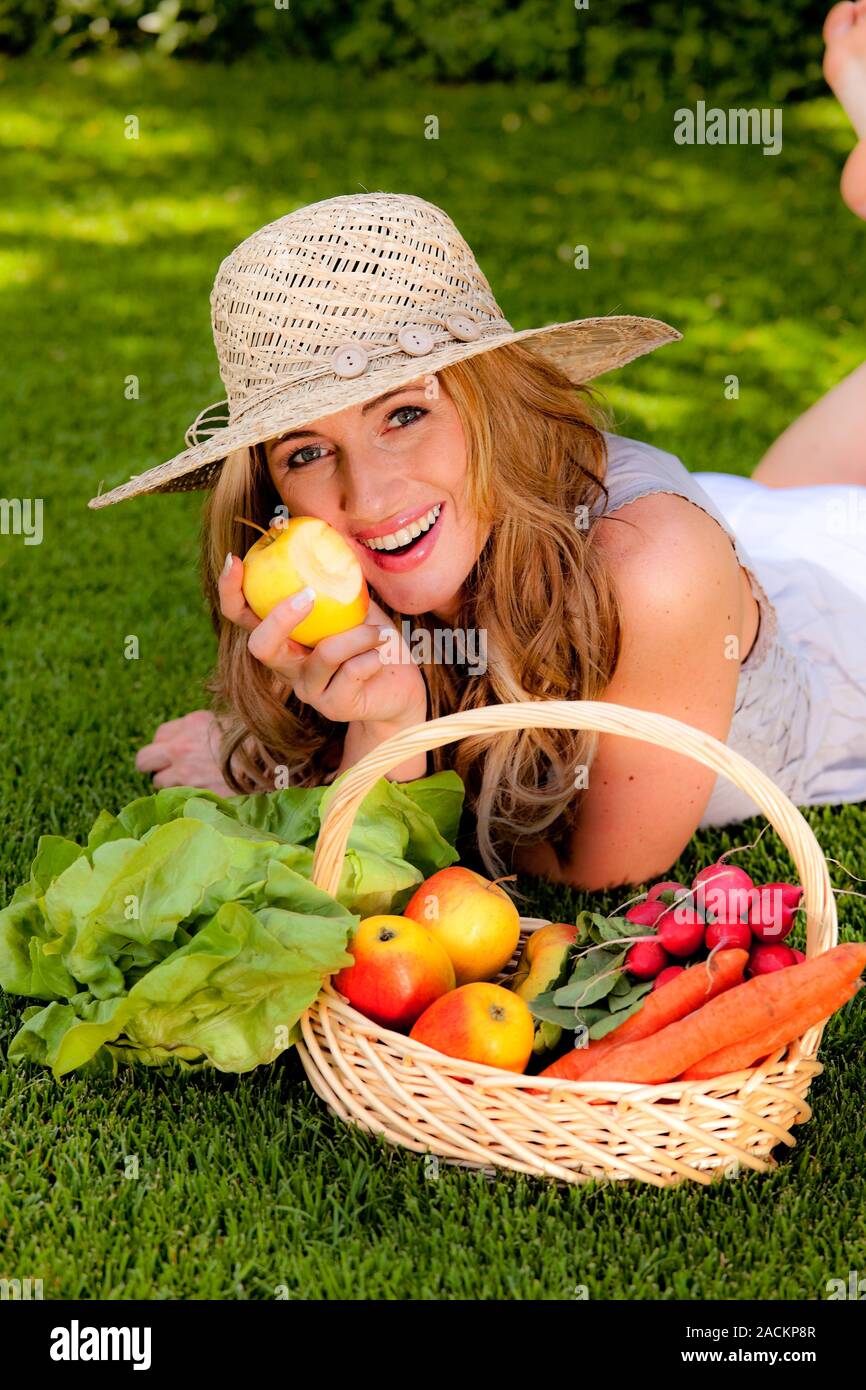 Fruit and vegetables in a basket with a woman Stock Photo - Alamy