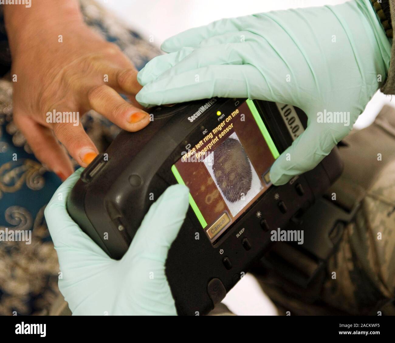 Military biometrics. Biometric fingerprint scanner being used by a US