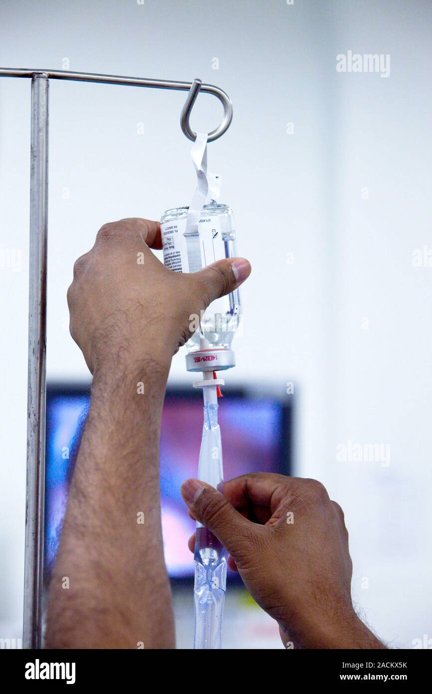 Adjusting the flow rate of an intravenous (IV) drip in a hospital