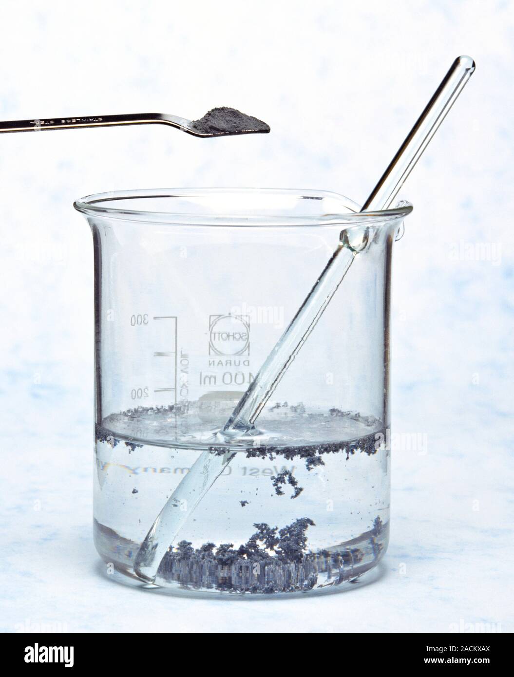 Zinc sulphate formation. Spatula being used to add zinc powder to