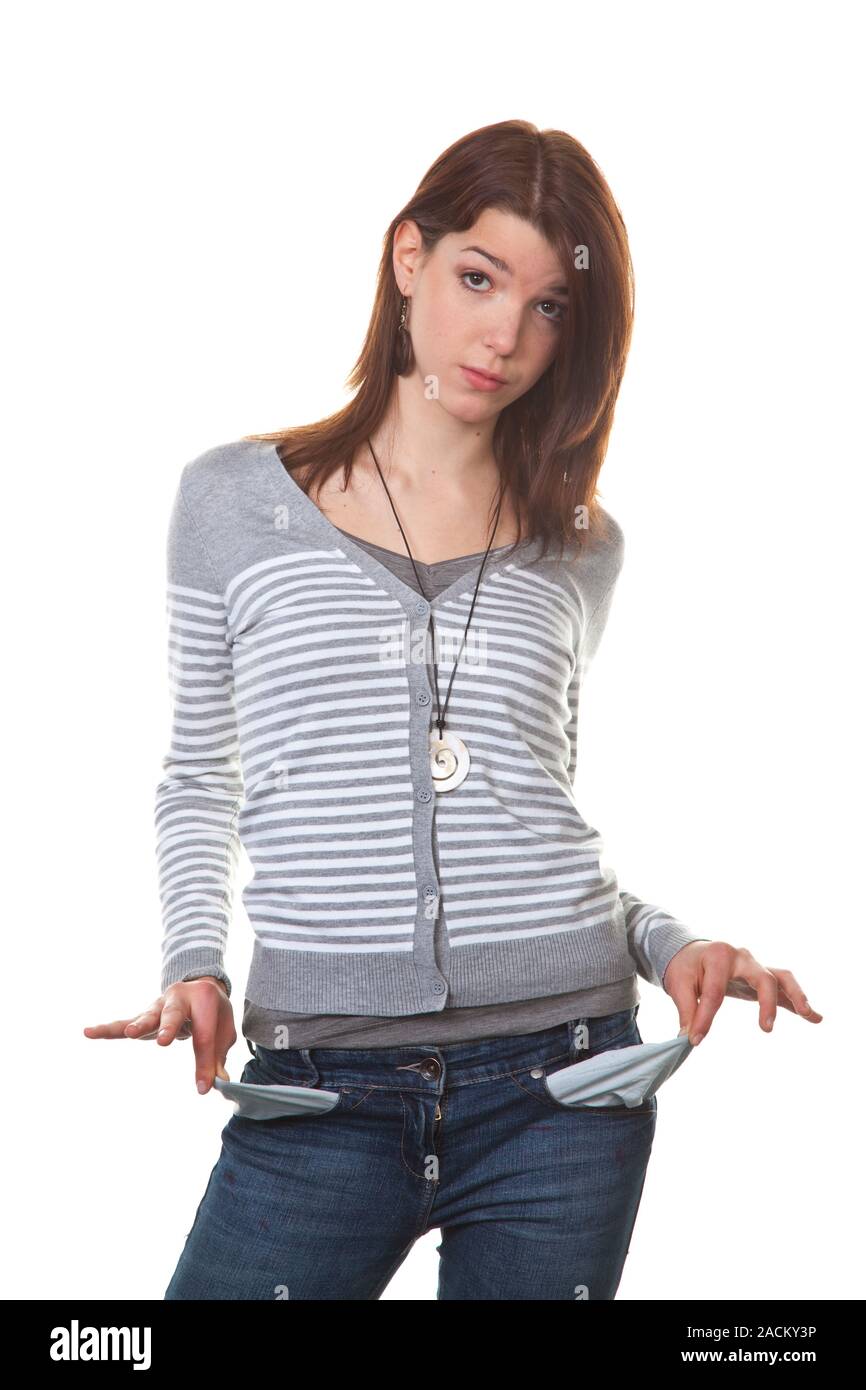 Broke, young woman shows her empty pockets Stock Photo