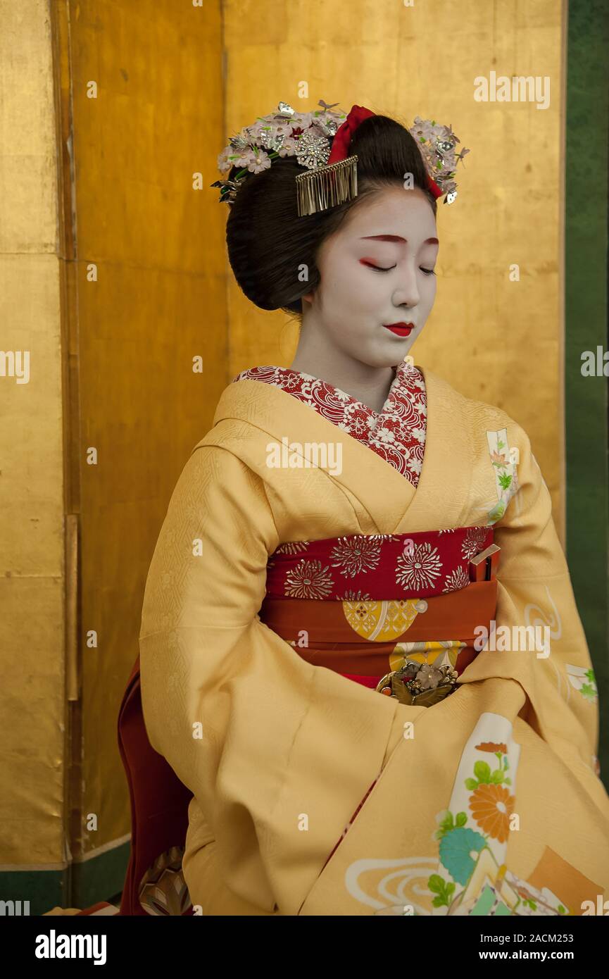 Kyoto, Japan - April 2014: A Maiko, or young Geiko in training performs traditional dance at a cultural event to entertain the guests Stock Photo