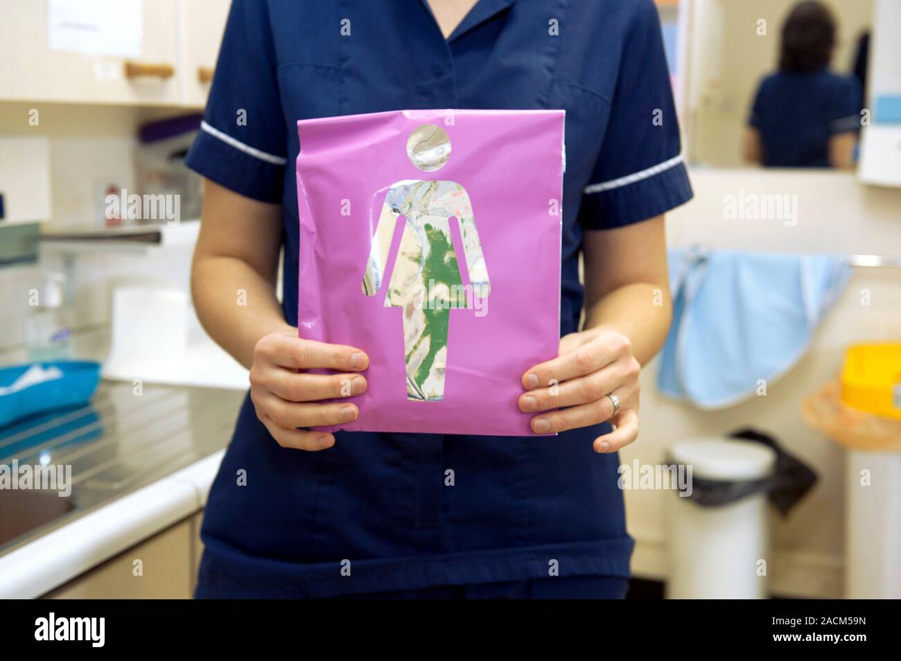 Nurse holds a female Chlamydia selftesting kit to detect Chlamydia