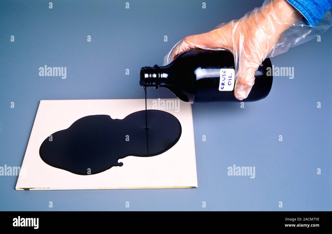 Crude oil being poured from a bottle onto a laboratory ceramic tile as