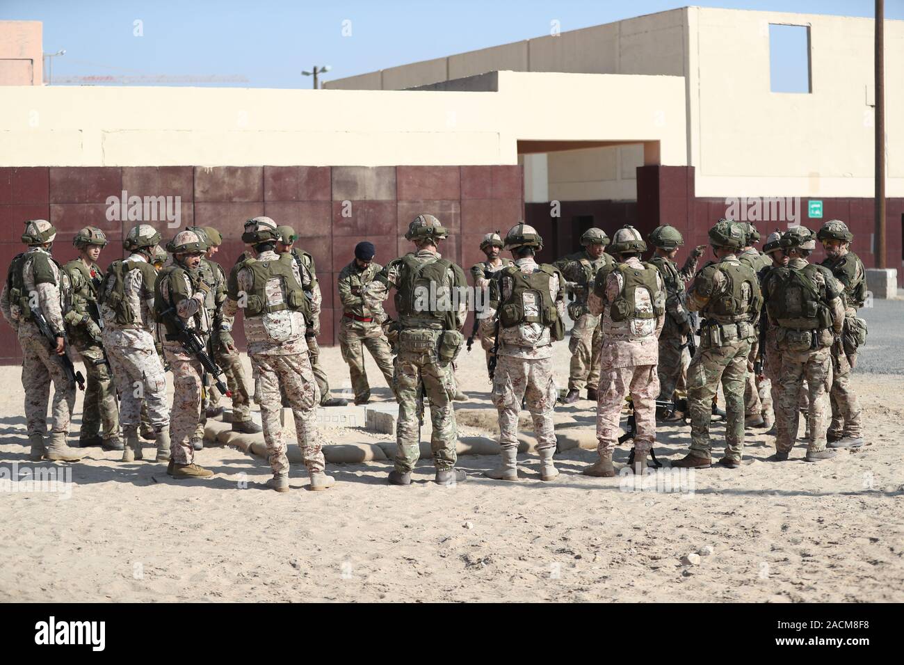 UK and Kuwaiti soldiers taking part in Exercise Desert Warrior await the arrival of the Duke of Cambridge at the Sheikh Salim Al-Ali National Guard Camp in Kuwait. Stock Photo