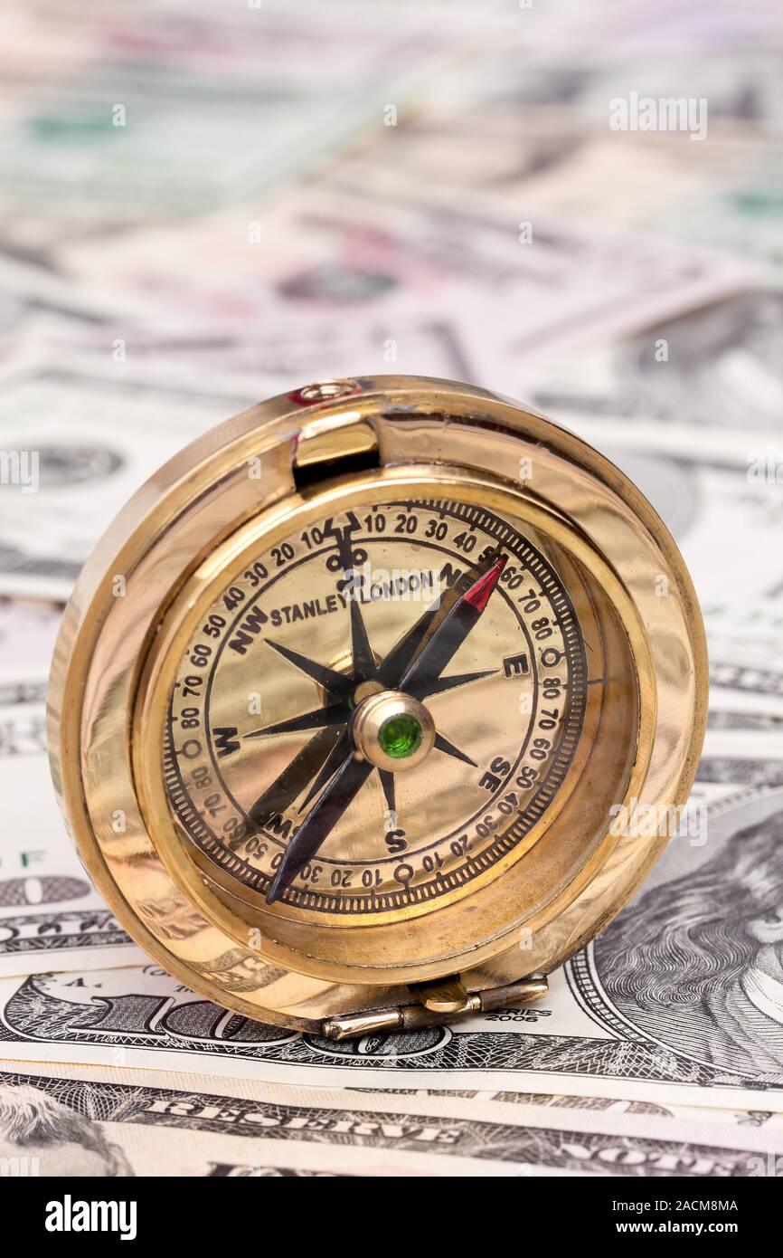 Dollar banknotes and compass Stock Photo - Alamy