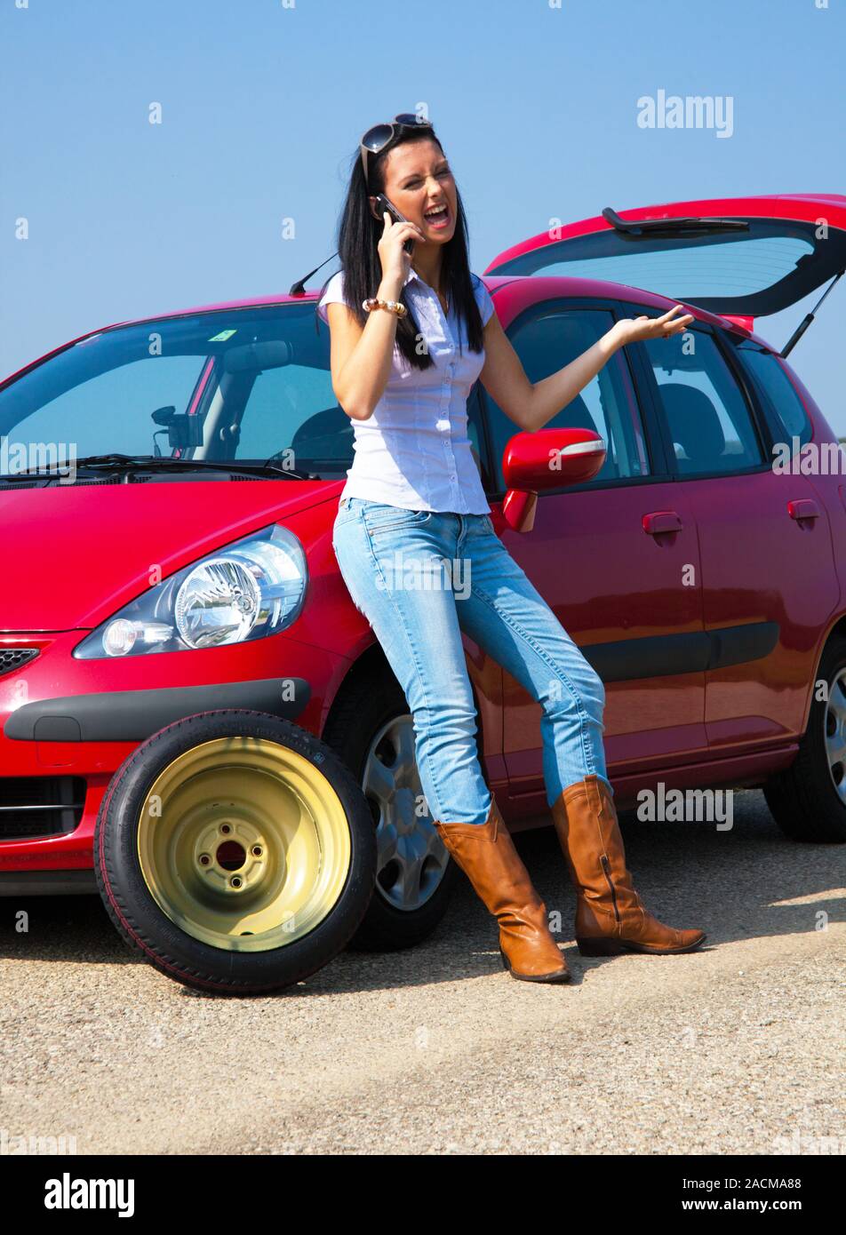 Woman with a flat tire in her car Stock Photo Alamy