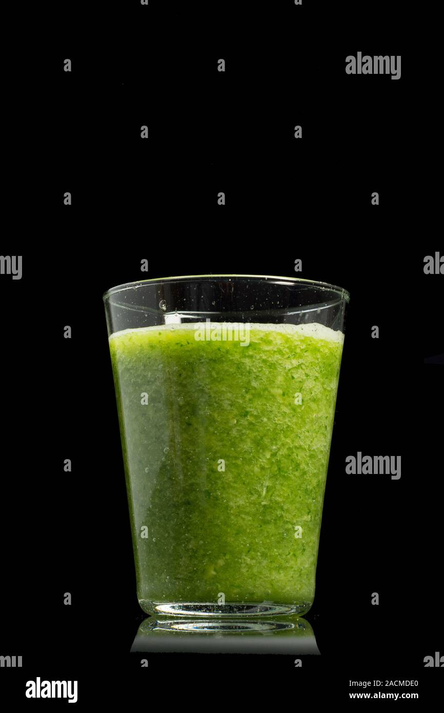 Fresh green healthy cucumber smoothie isolated on black background Stock Photo