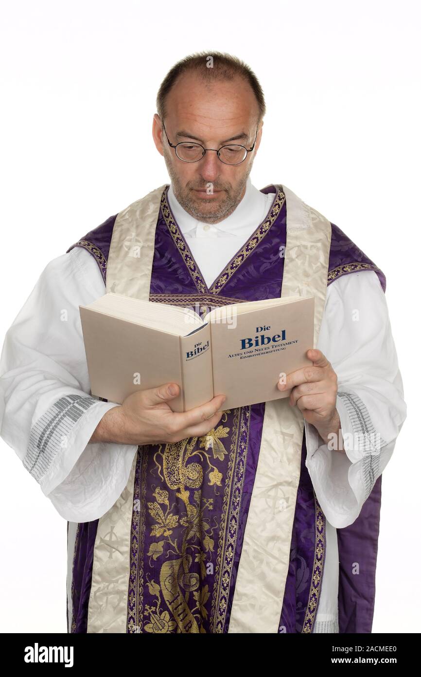 catholic priest with bible in church service Stock Photo Alamy