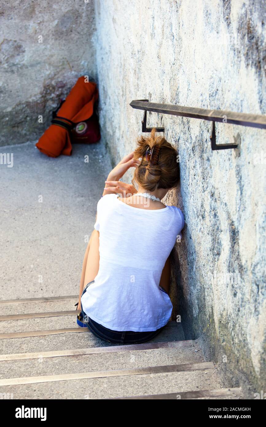 Woman sitting on steps Stock Photo